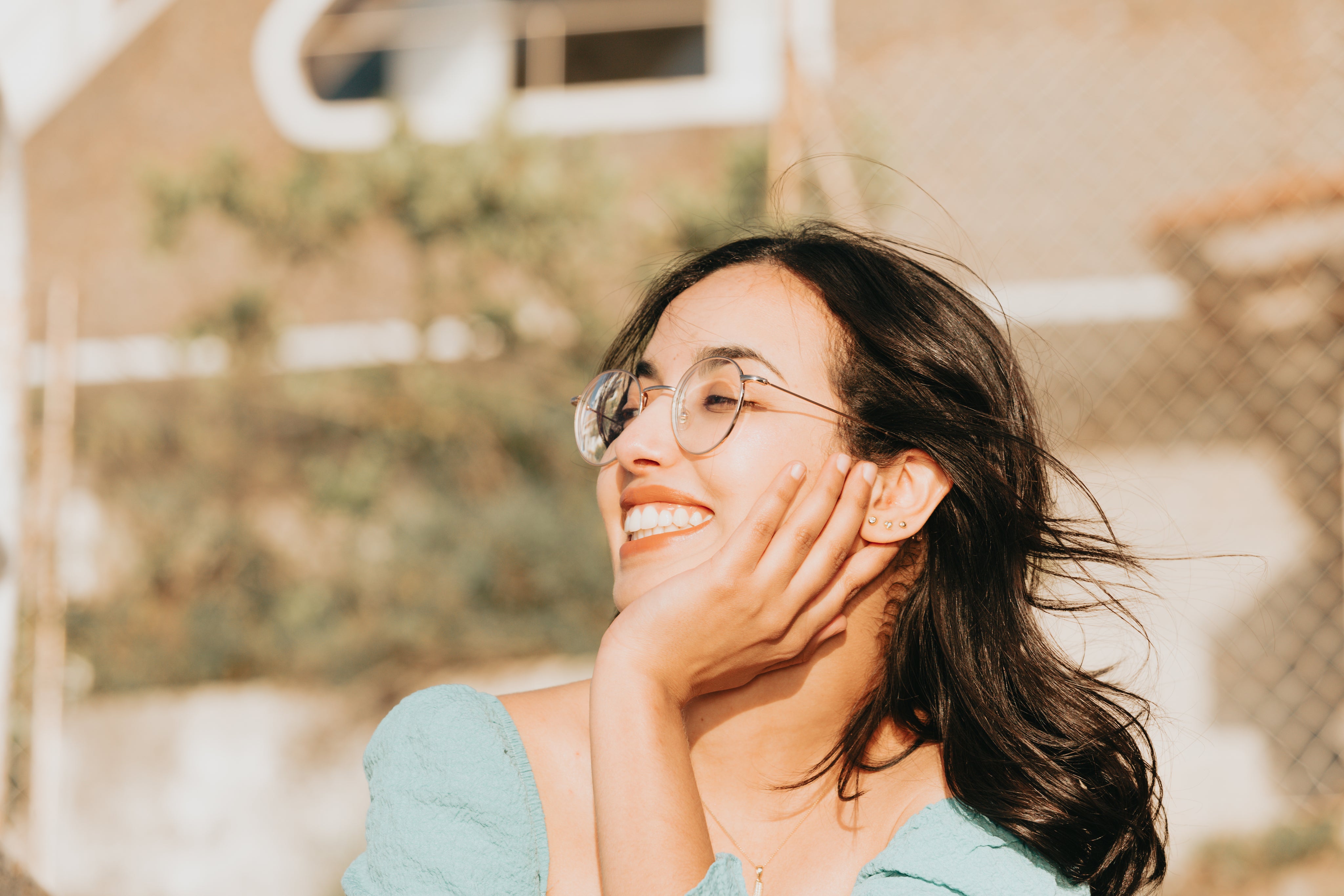 files/woman-smiling-and-holding-her-head-up-with-one-hand.jpg